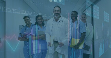 Standing team in scrubs and coats analyzing patient data in hospital hall with digital charts