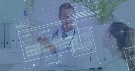 Gesturing male physician consulting patient in medical office, with holographic data panels