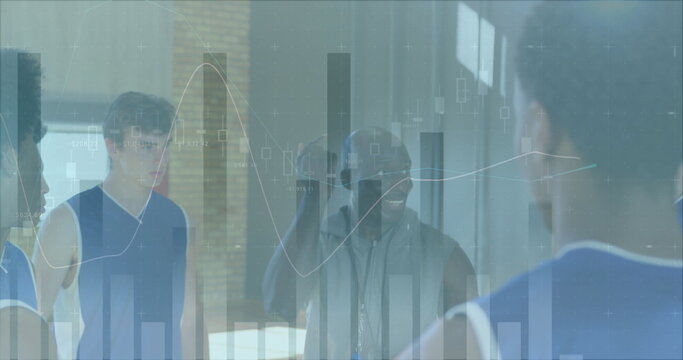 Holding basketball coach speaking to players in blue jerseys on gym court, with data charts overlay