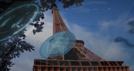 Displaying Eiffel Tower rising at Tower base against sky, showing tree branches and HUD circles © vectorfusionart
