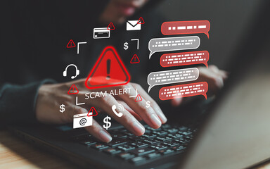 Hands typing on laptop with scam alert warning surrounded by fraud icons including email phishing,...
