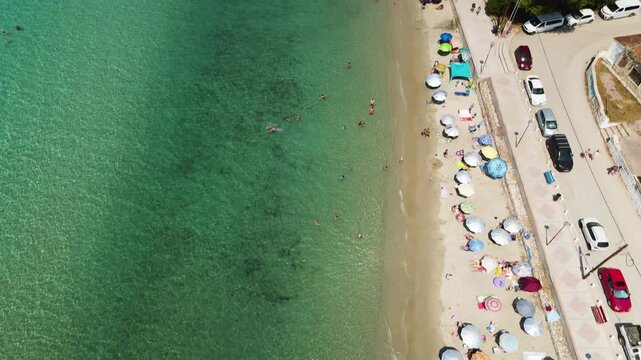 Siviri beach, sea and hotels in Kassandra Halkidiki, Greece. Incredible clear blue water. Aerial panoramic drone view from above, top view from drone. Summer holidays Europe
