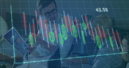 Team in business attire examining charts and laptop in meeting room, with digital overlay