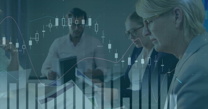 Reviewing financial reports business professionals gathering around conference table, with laptop