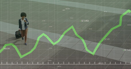 Walking businesswoman pulling suitcase using smartphone on city sidewalk with overlay, copy space