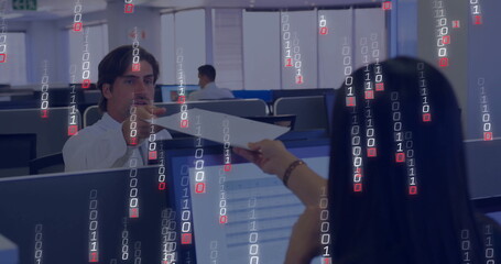 Mid adult White man wearing shirt reaching to take paper at office, with monitors, binary overlay