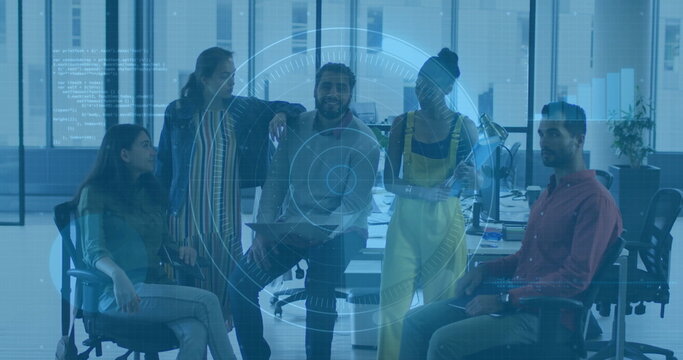 Five coworkers collaborating around desk in modern office, with laptop and holographic overlay - Powered by Adobe