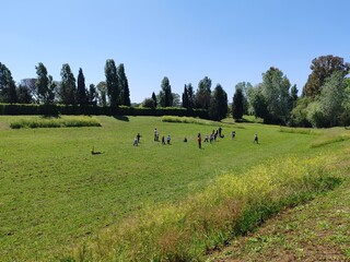Ostia, Rome, April 15, 2025, children from an elementary school, on a school trip, have fun running and playing in a protected ecological oasis.