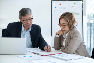 Asian business professionals discussing financial data strategy in modern office collaboration meeting for growth analysis