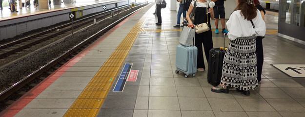 新大阪駅のホームで電車待ちの人々の観光客の姿