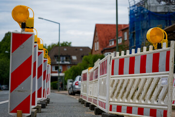 Roadworks closure with plastic barrier, lamps and scaffolded site