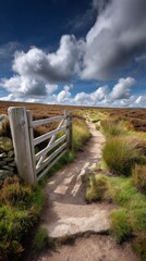Fototapeta premium Rustic wooden gate and stile in countryside landscape