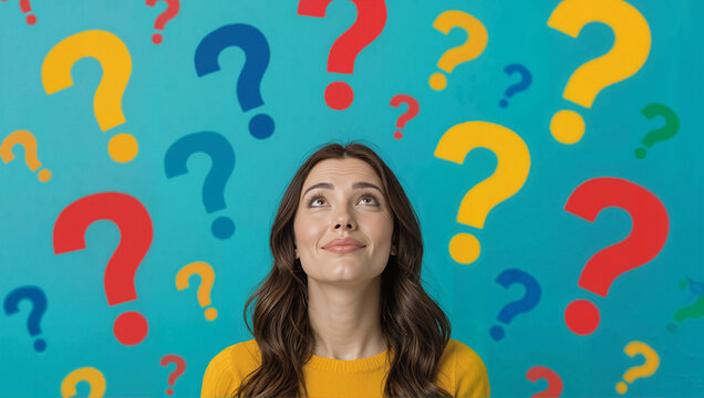 Woman looking up surrounded by colorful question marks