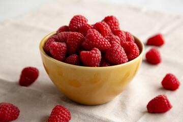 Organic Raw Red Raspberries in a Bowl, side view. Close-up.