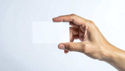 Hand holding blank business card on white background