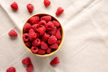 Organic Raw Red Raspberries in a Bowl, top view. Copy space.