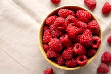 Organic Raw Red Raspberries in a Bowl, top view. Copy space.