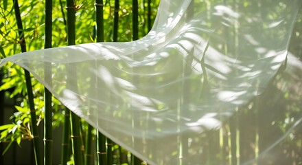 Flowing White Fabric Billows in Gentle Breeze Amidst Lush Bamboo Forest