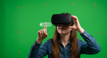 Woman using virtual reality headset interacts with digital interface, exploring immersive futuristic technology experiences.