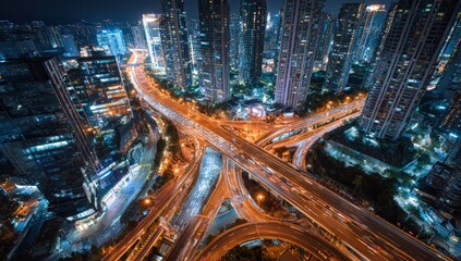 Aerial view of a complex highway interchange at night in a large city