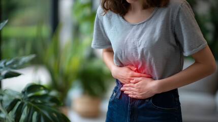 Minimalist medical concept illustration style photo of young woman wearing casual jeans and top, standing with hands over abdomen, red highlight showing pelvic pain, linked to uter