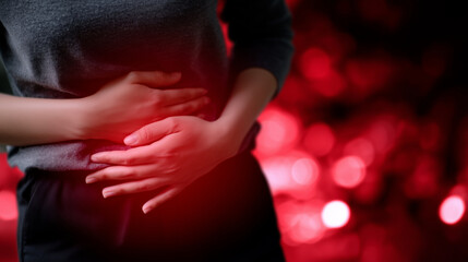 Close-up of abdomen area with hands pressing gently, red overlay to indicate pain source, concept for medical awareness of endometriosis, ovarian or uterine diseases
