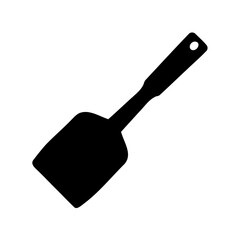 A black silhouette illustration of a kitchen spatula on a white background