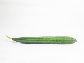 Fresh green luffa gourd isolated on white background. Natural tropical vegetable used for cooking,...