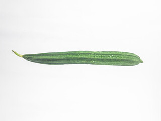 Fresh green luffa gourd isolated on white background. Natural tropical vegetable used for cooking,...