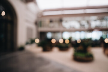 Blurred Interior of Modern Indoor Garden Area with Soft Lighting and Lush Greenery in Contemporary Architecture