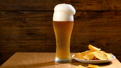 A refreshing glass of beer with tortilla chips