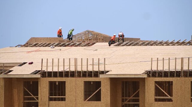 House roof. Roofing construction. Roofer on new roof under construction building. Roofing tiles. Repairing building roof. Repair roofs, install roofing. Frames roof. Timber Frame House.