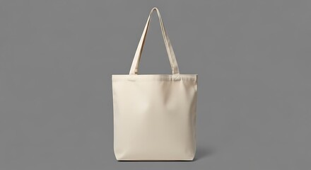 A plain beige canvas tote bag isolated on a plain grey background