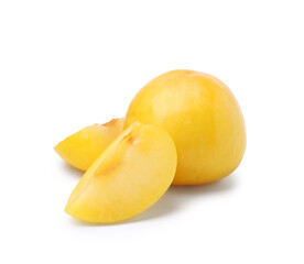 Whole and cut yellow cherry plums isolated on white