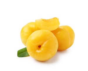 Whole and cut yellow cherry plums with leaf isolated on white