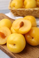 Ripe yellow cherry plums on grey table, closeup