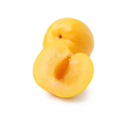 Whole and cut yellow cherry plums isolated on white