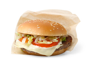 One delicious burger with cheese, tomato, lettuce and patty in takeaway package isolated on white. Tasty fast food