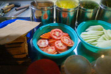 Freshly sliced tomato and cucumber ready for serving at stall