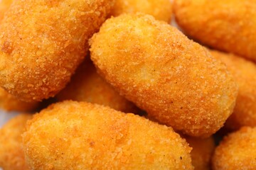 Delicious fried croquettes as background, top view