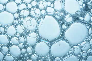 Beautiful foam texture in blue tones. Bubbles of detergent or bubble bath.