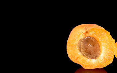 Ripe organic apricots isolated on black background, macro.