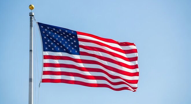 The american flag a symbol of freedom, liberty, and patriotism waving proudly in the wind against a clear blue sky, representing the united states