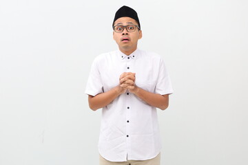 Impressed fascinated young asian muslim man open mouth astonished gasping surprised hold hands,...