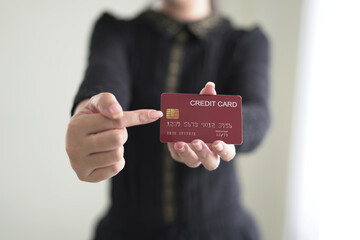 Female hands holding and pointing credit card for secure payment, shopping and paying online,...