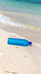 Plastic bottle on a sandy beach