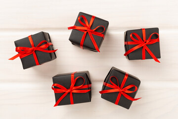 Black gift boxes on wooden background, top view. Black Friday concept