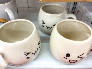 Adorable White Mugs with Hand Drawn Emoticons on Display
