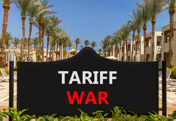 Trade tariff war symbol. Concept word Tariff war on beautiful black road sign. Beautiful palm trees...