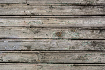 Wooden background. An old wooden wall with remnants of paint.
